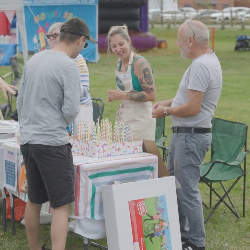 Visitors and volunteers at a Summer Fair stall on the Village Green