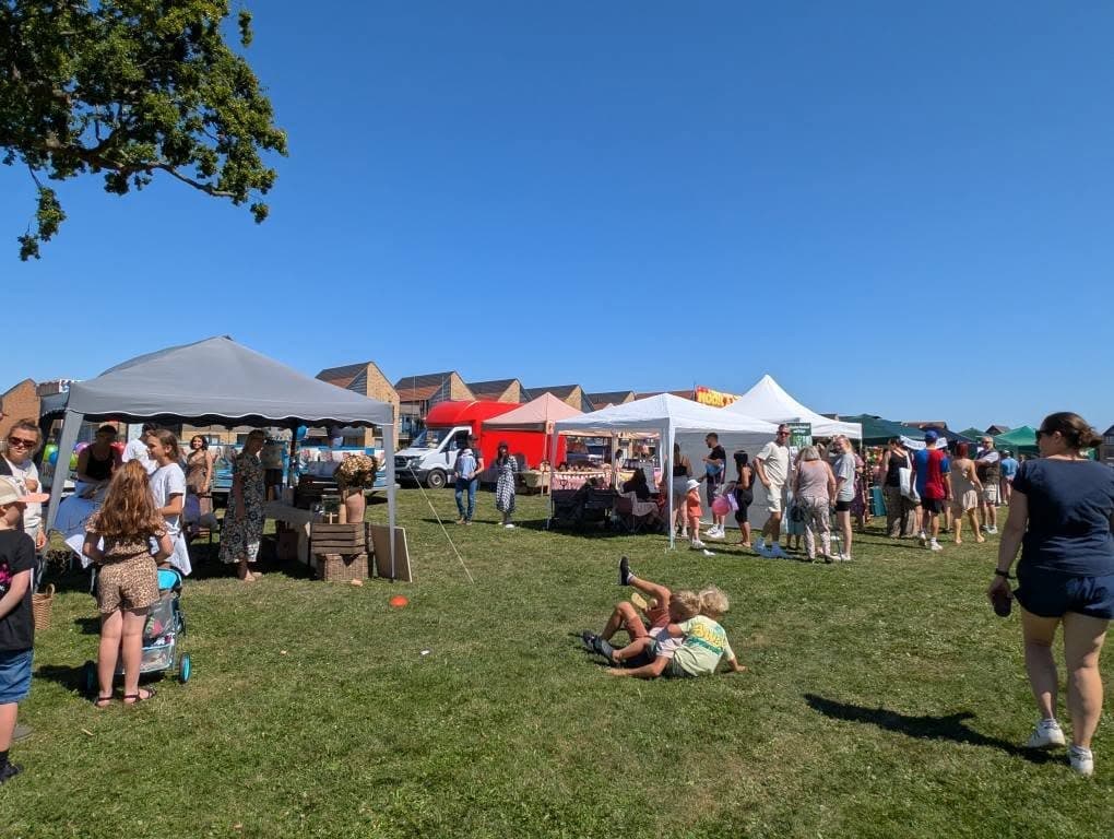 Stalls and visitors at the 2025 Woodgate Summer Fair on the Green